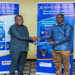 Project Manager Dr Zacharia Malima hands over copies of the Yearbook 2025 report to Patrick Kipangula, the Acting Director of the Journalists Accreditation Board (JAB).